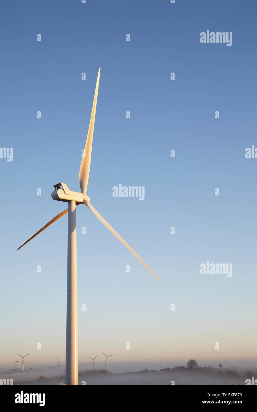 Wind turbine against blue sky Stock Photo - Alamy