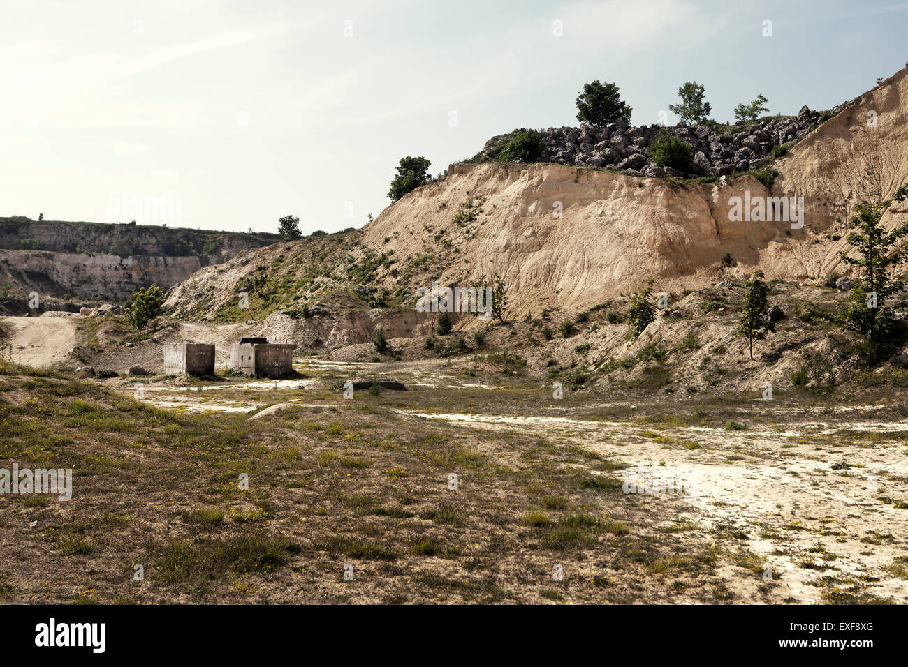 Abandoned quarry with dirt track and concrete blocks Stock Photo