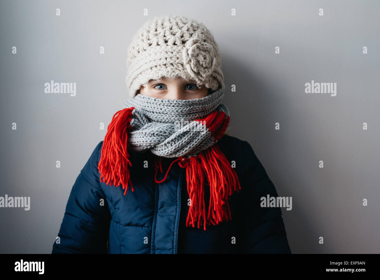 Girl warmly wrapped up in woollen hat and scarf Stock Photo