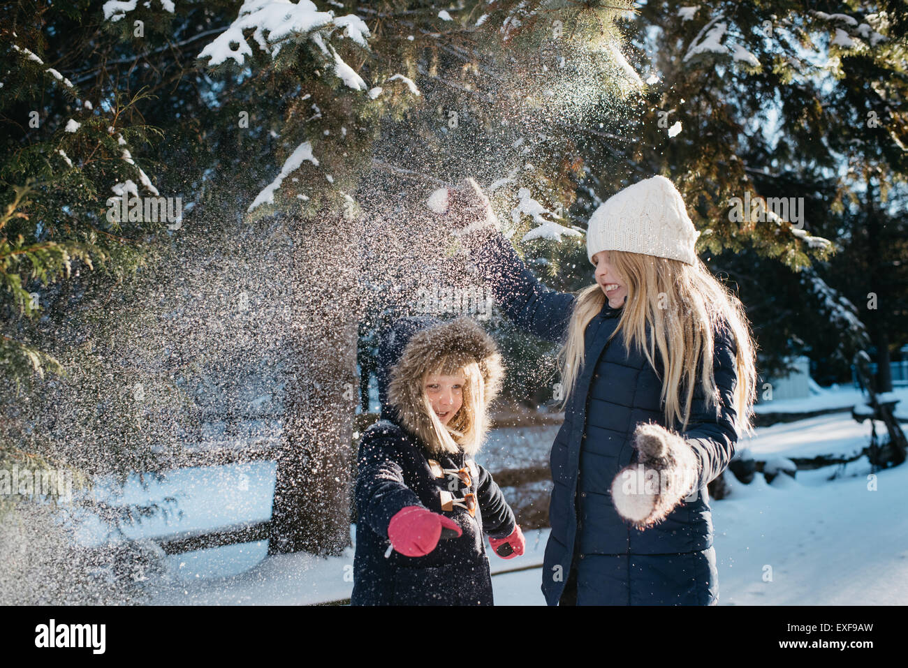 Sisters playing in the snow Stock Photo - Alamy