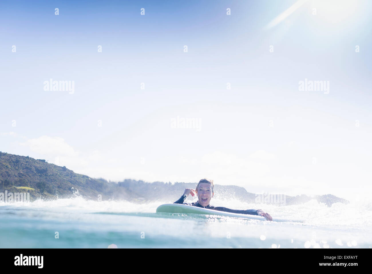 Surfer in the water, Bay of Islands, New Zealand Stock Photo
