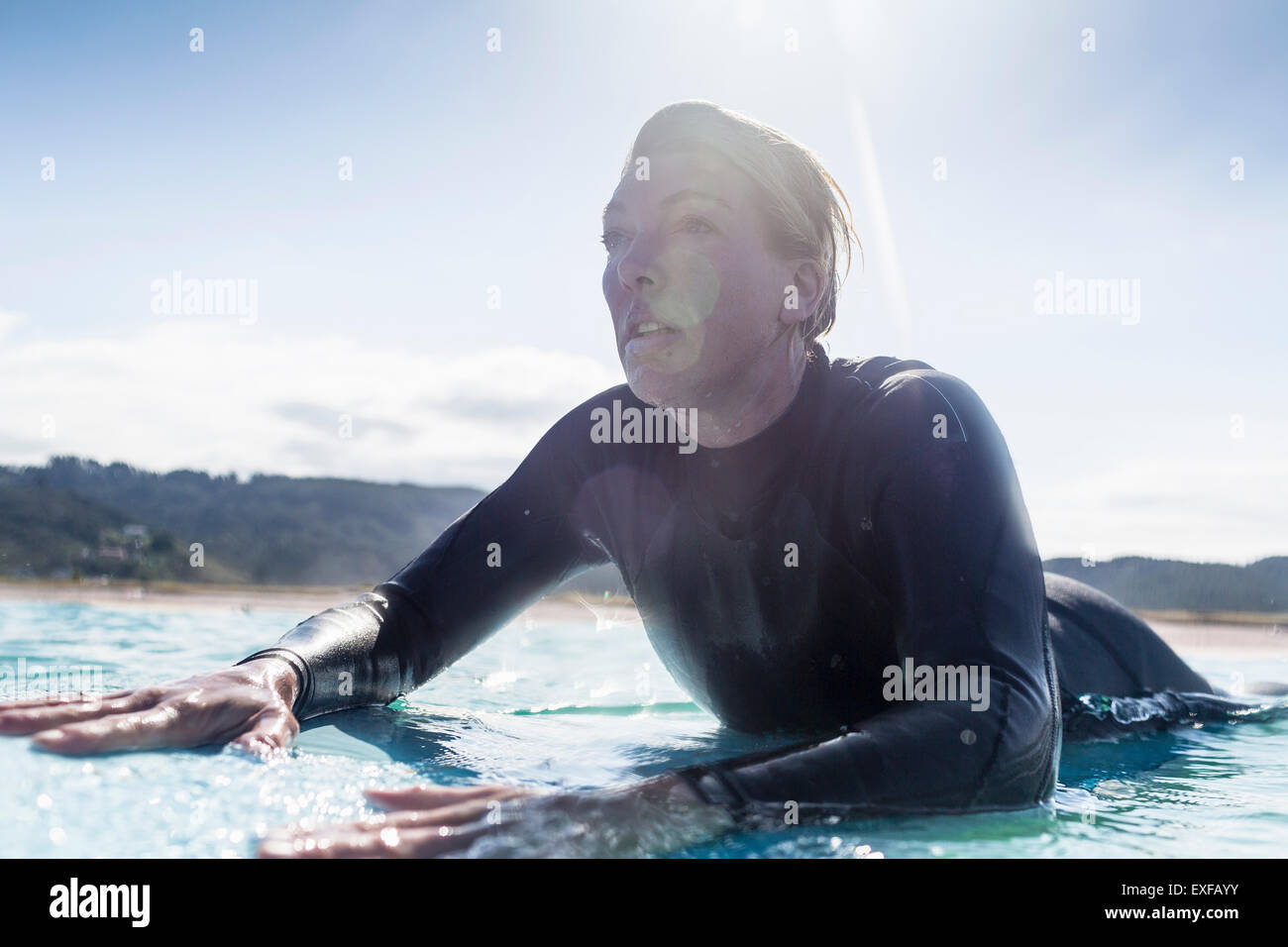 Surfer in the water, Bay of Islands, NZ Stock Photo