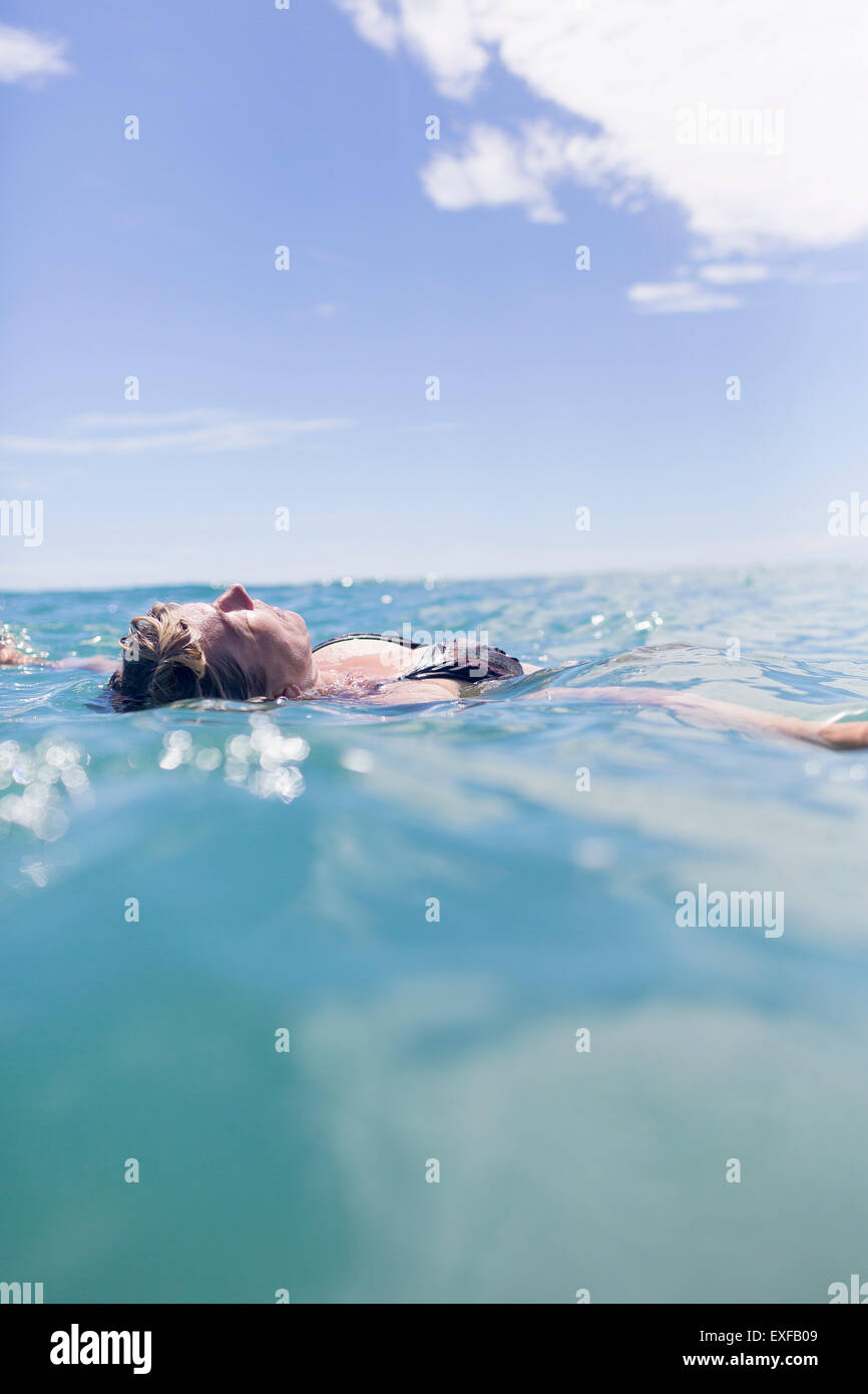 Swimmer floating in sea Stock Photo