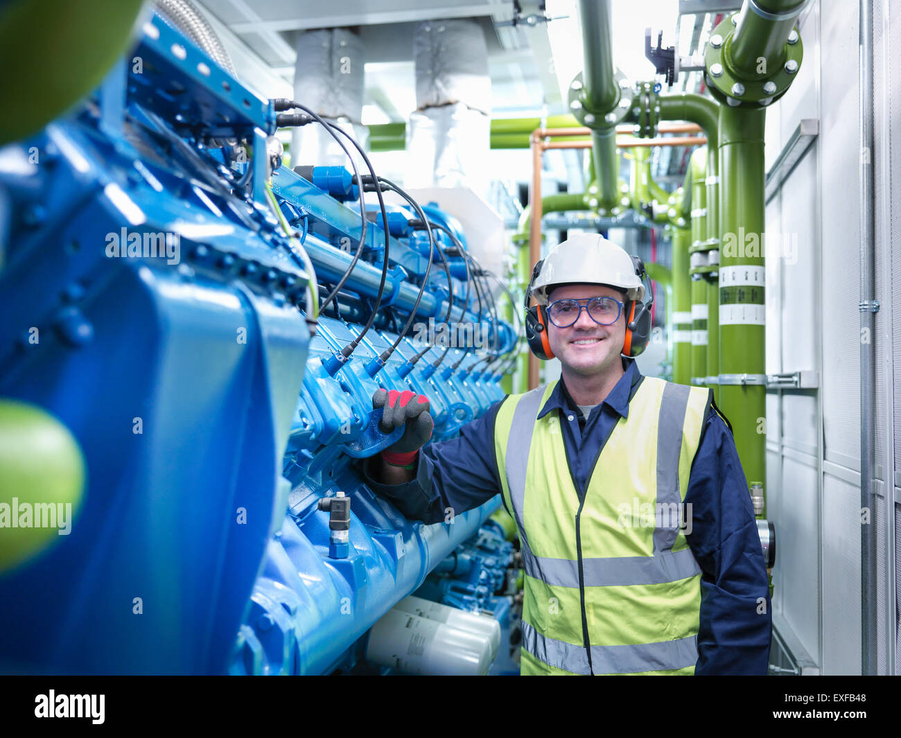 Worker with gas fired generator in gas fired power station Stock Photo