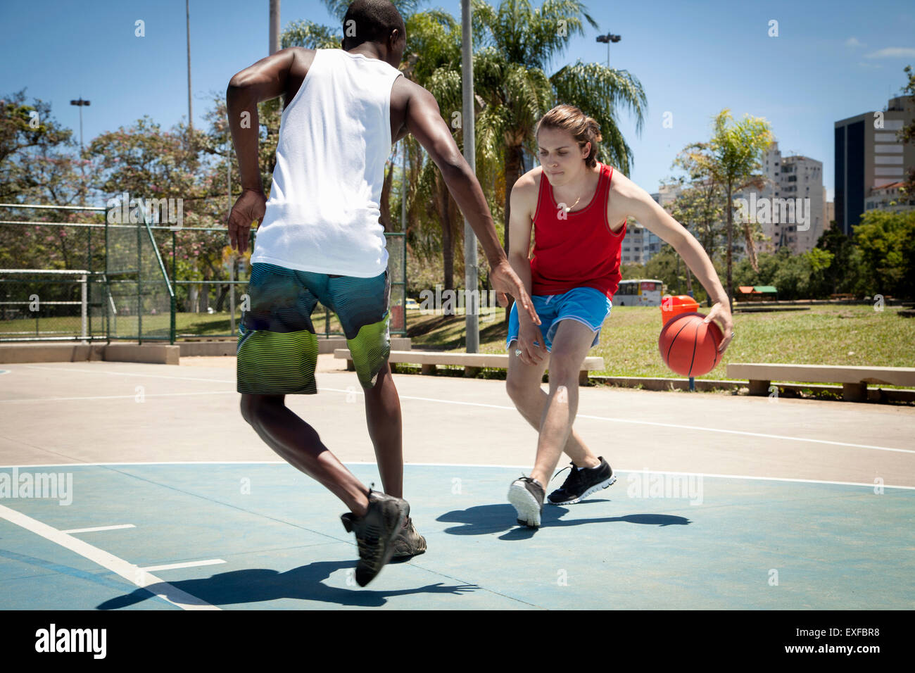 Young men practicing basketball on basketball court Stock Photo