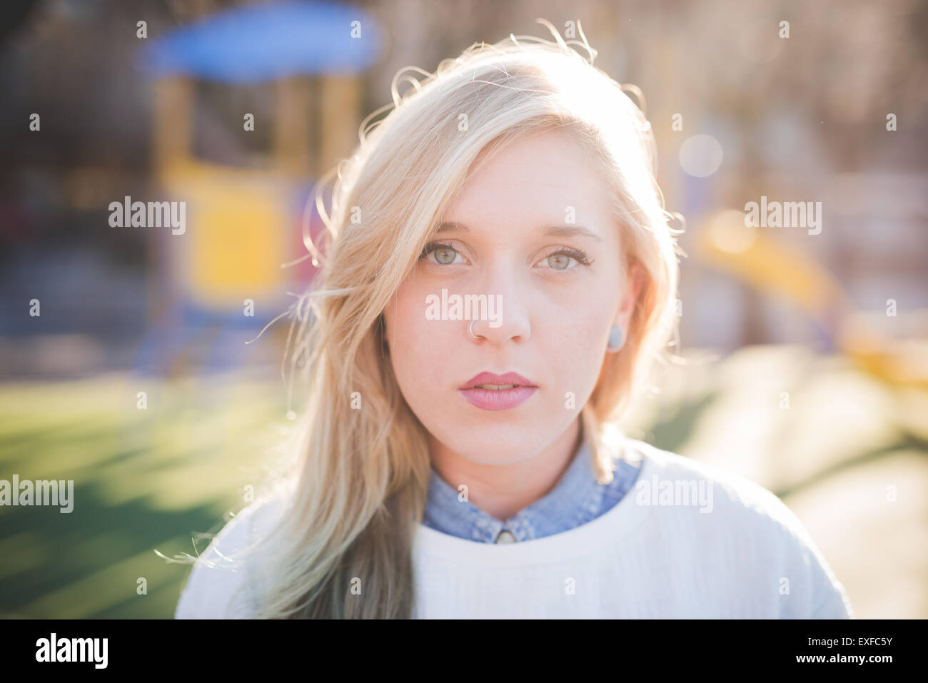 Portrait of beautiful young woman in park Stock Photo - Alamy