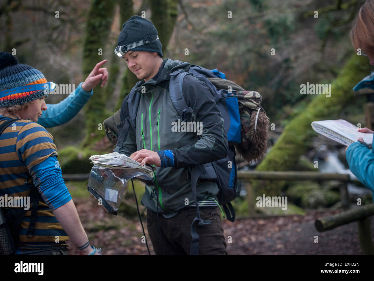 Young man with map preparing to go orienteering Stock Photo
