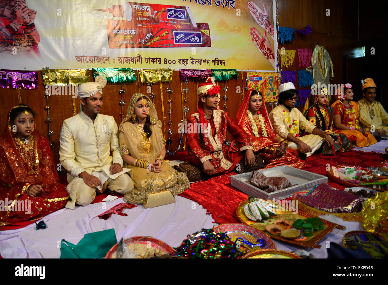 Dhaka, Bangladesh. 13th July, 2015. Bangladeshi newly married couples participated in the marriage festival at National Museum's auditorium in Dhaka, Bangladesh. On July 13, 2015  A social organization 'Capital Dhaka 400 years celebration Committee' organized a marriage festival at National Museum's auditorium in Dhaka. Newly married couple participated and marriage ceremony's equipments exhibited in the marriage festival. Credit:  Mamunur Rashid/Alamy Live News Stock Photo