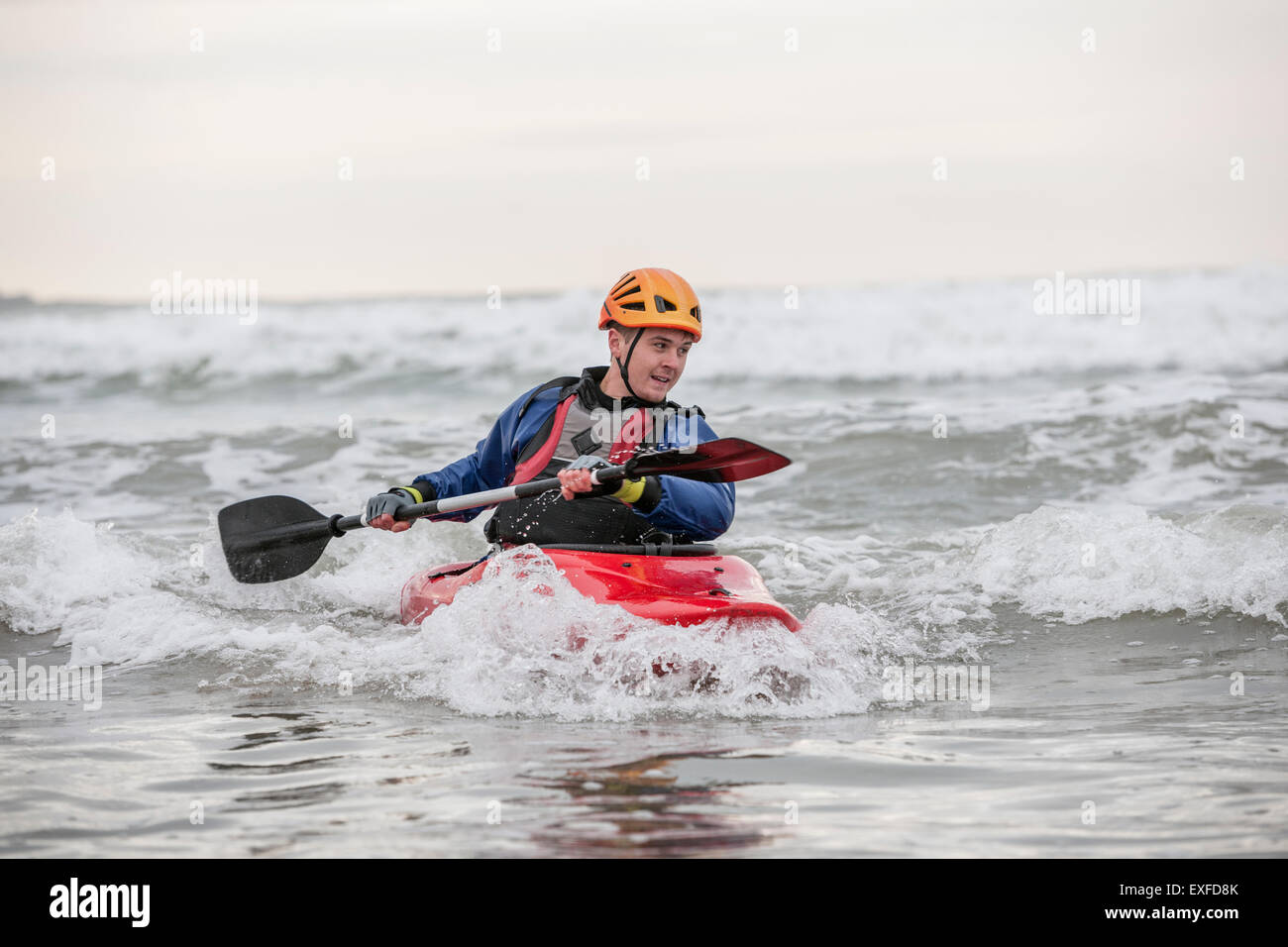 Young man sea kayaking Stock Photo