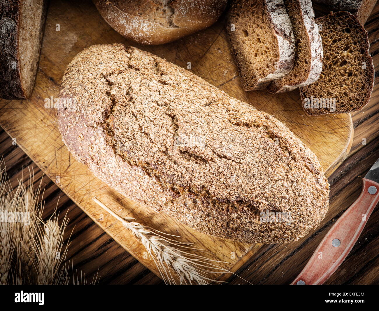 Rye-bread loaf on the wooden plank. Stock Photo