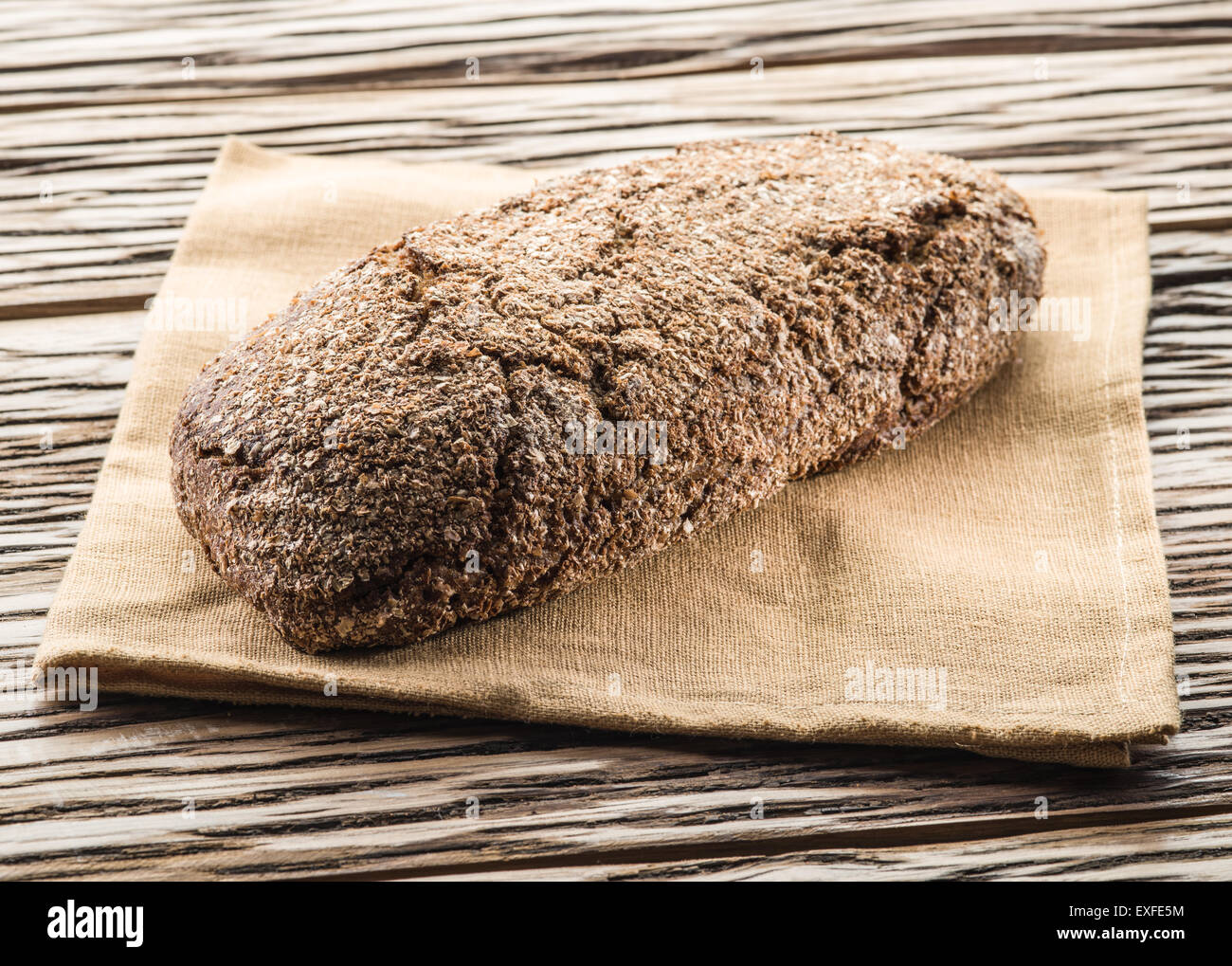 Long loaf on the wooden plank. Stock Photo