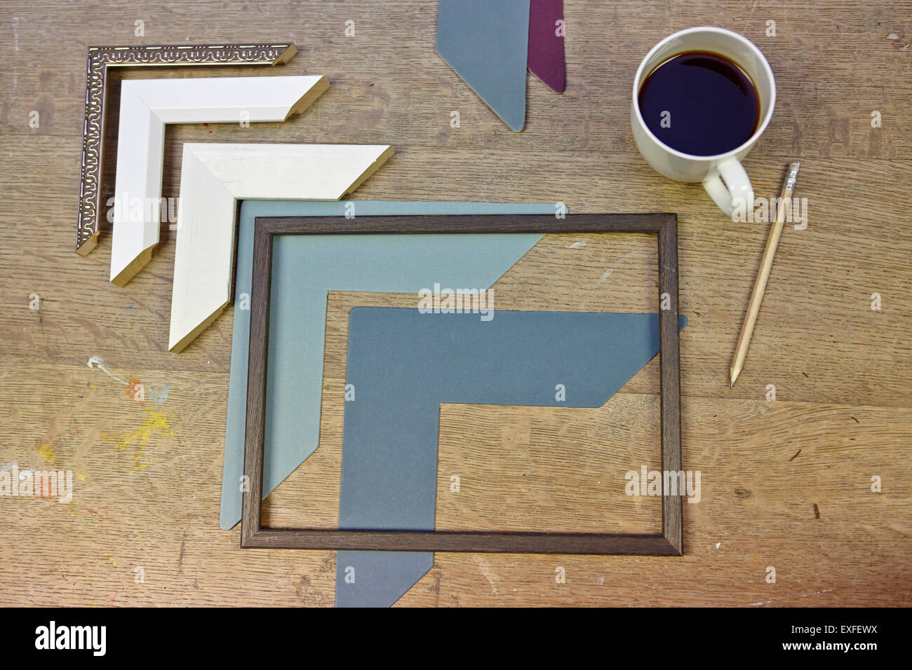 Still life of frames and coffee in picture framers workshop Stock Photo