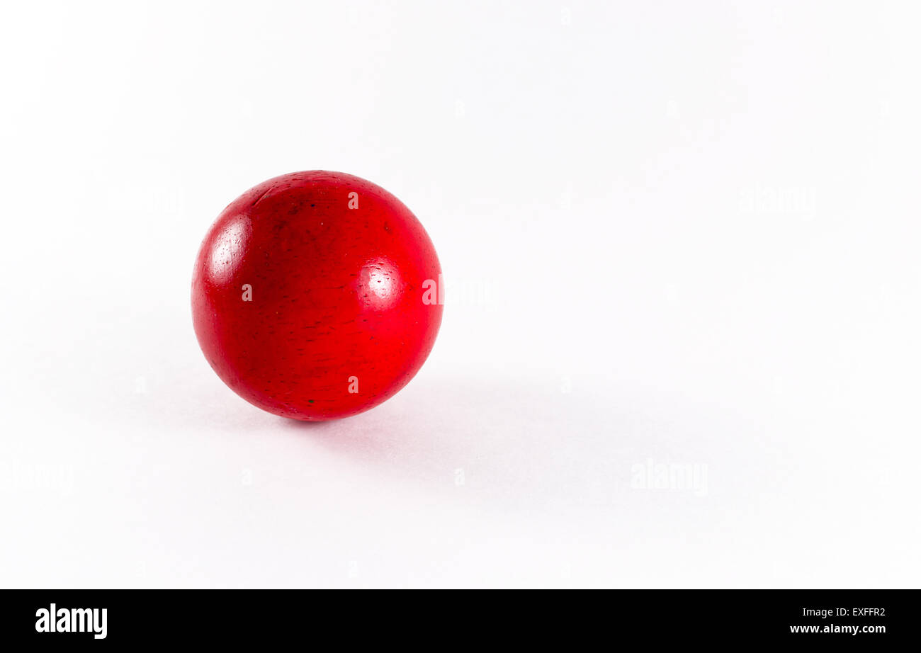 Single red wooden ball on a white background with copyspace Stock Photo