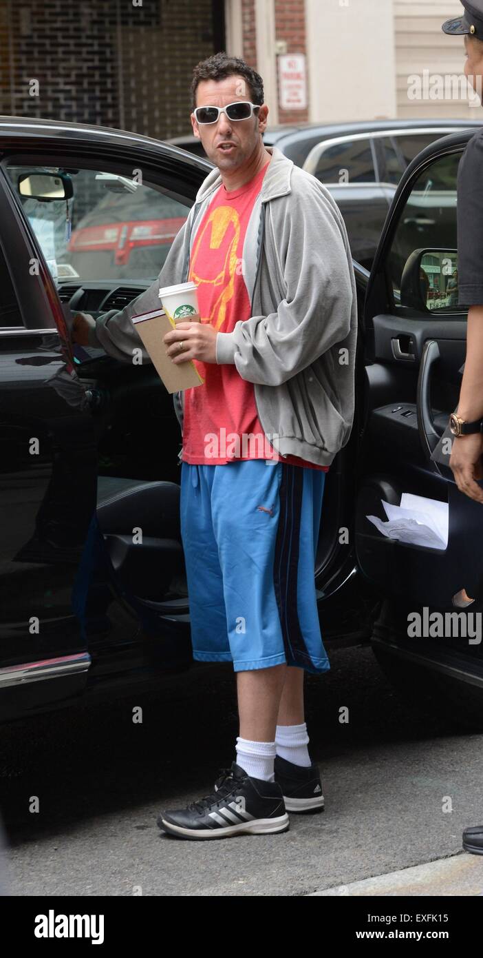Adam Sandler carrying a hot beverage and overdressed on a hot day in