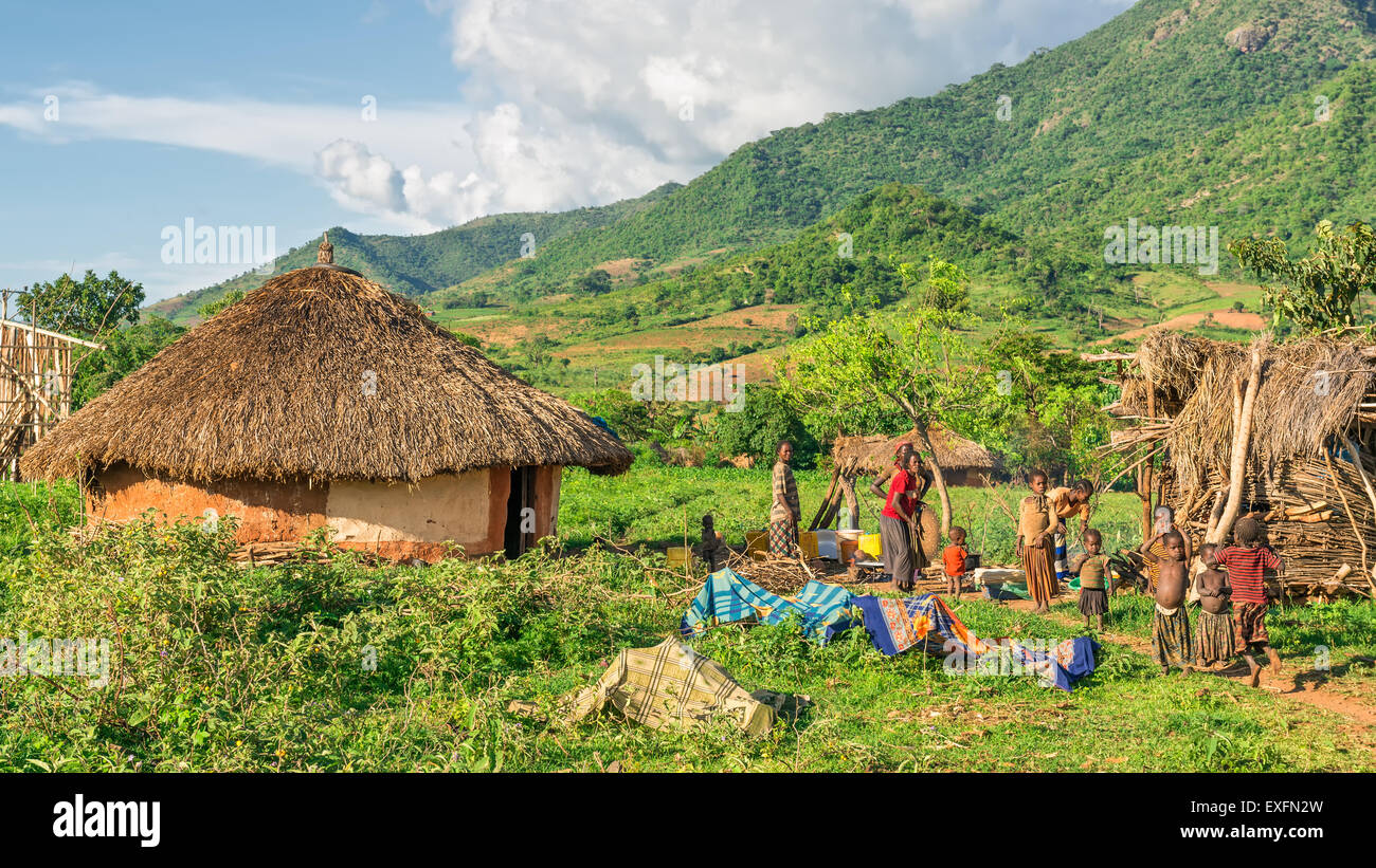 Ethiopian family preparing dinner in front of their home in the southern part of Ethiopia. Stock Photo