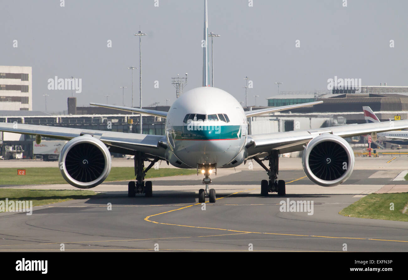 Cathay Pacific Boeing 777 taxiing on Manchester Airport taxiway. Stock Photo