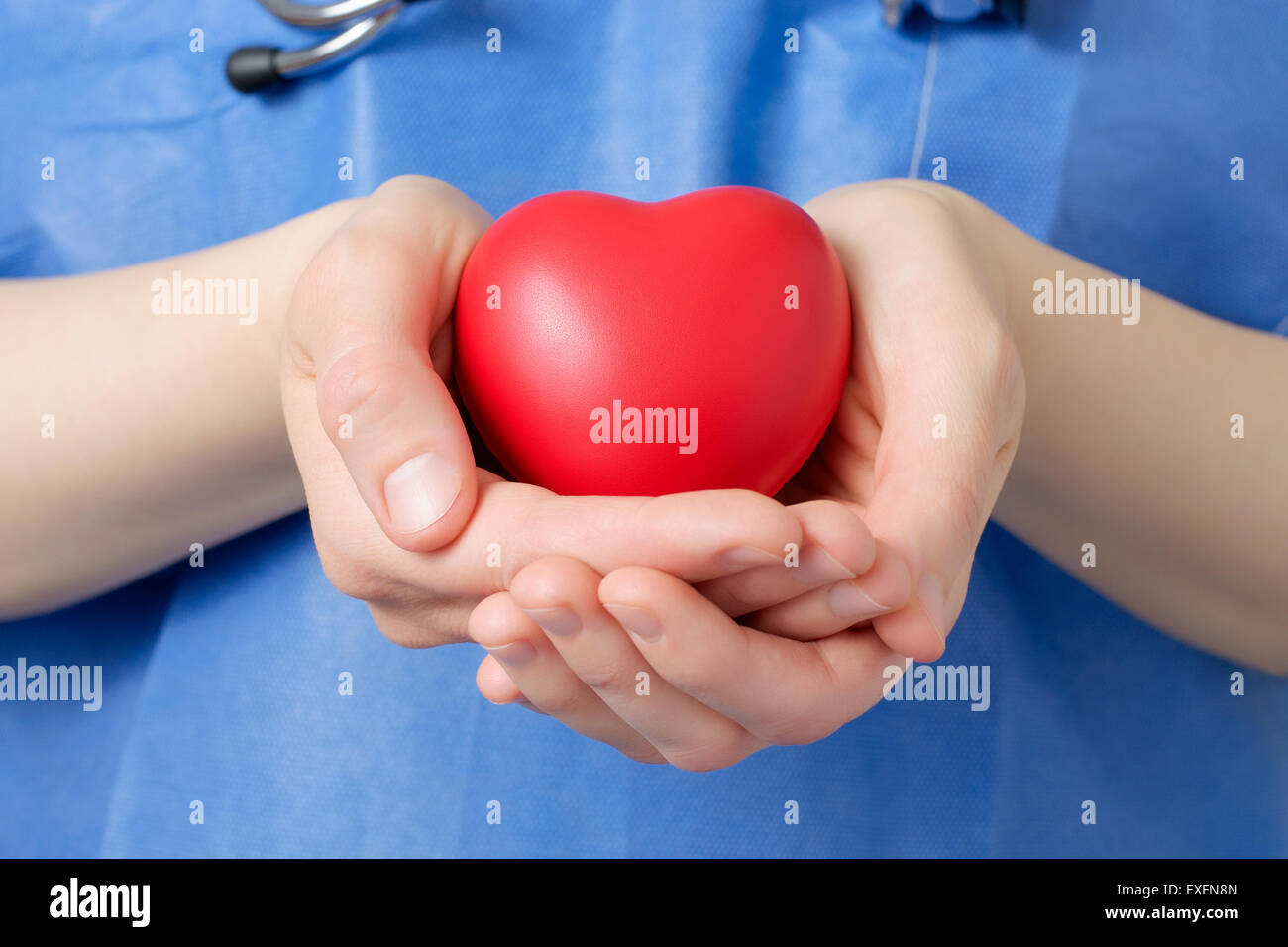 Female doctor holding a red heart shape Stock Photo