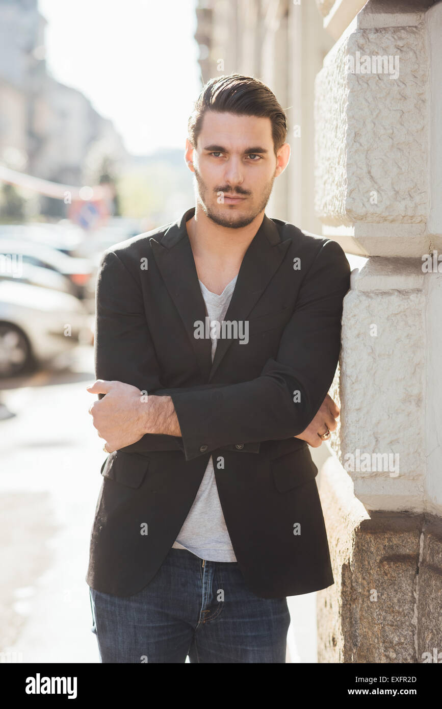 Knee-figure of a young handsome italian boy posing through the streets ...