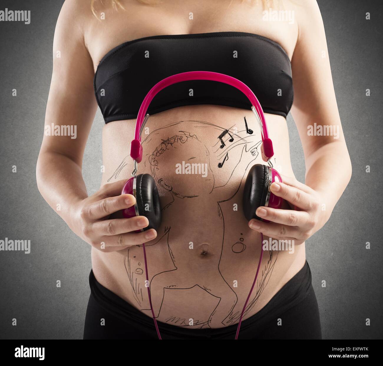 Hands of young pregnant woman put headphones with classical music on her pregnant  belly. Concept of intellectual intrauterine development of the child Stock  Photo - Alamy