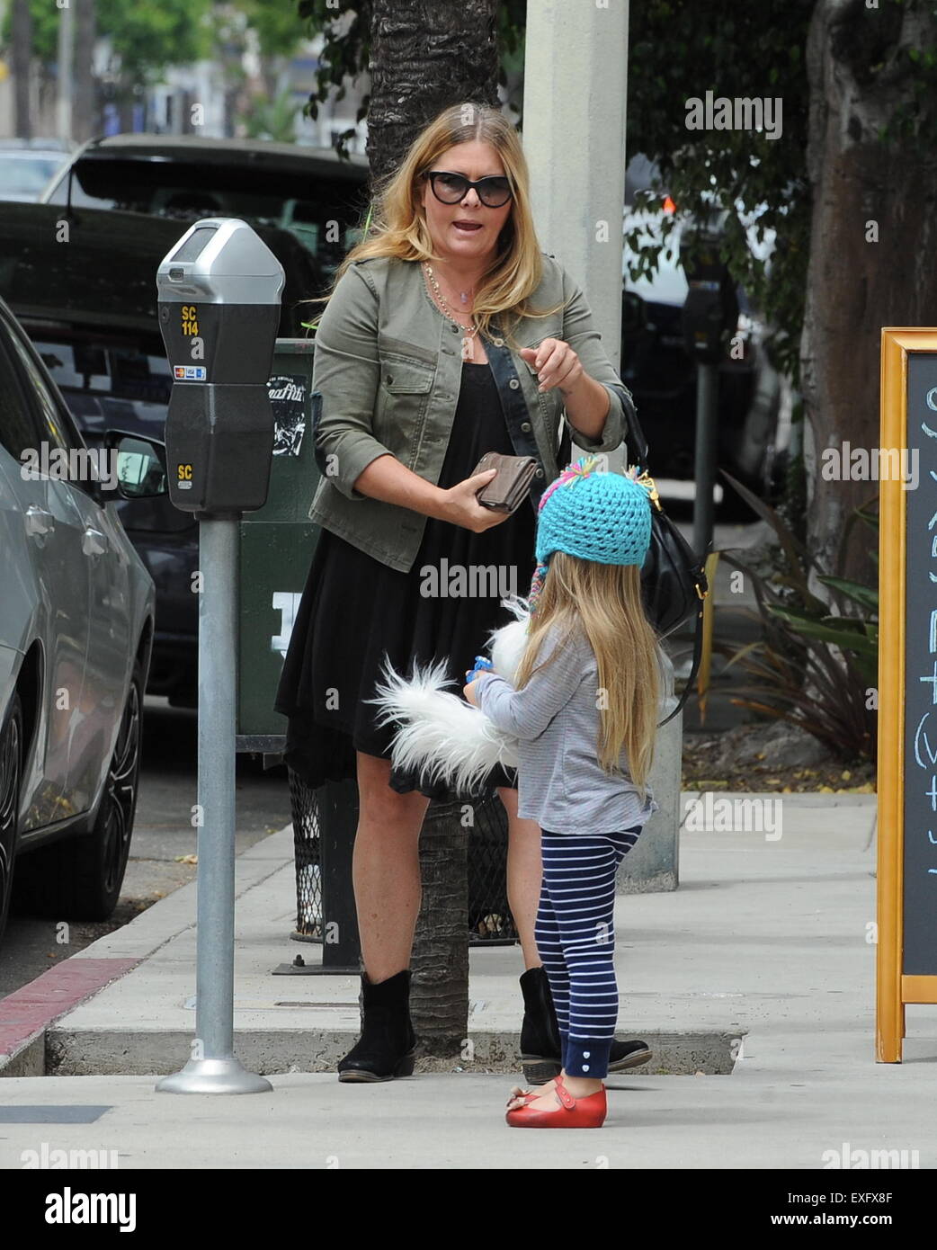 Ex baywatch babe Nicole Eggert feeds the meter before heading for brunch with her daughter in studio city.  Featuring: Nicole Eggert Where: Studio City, California, United States When: 12 May 2015 Stock Photo
