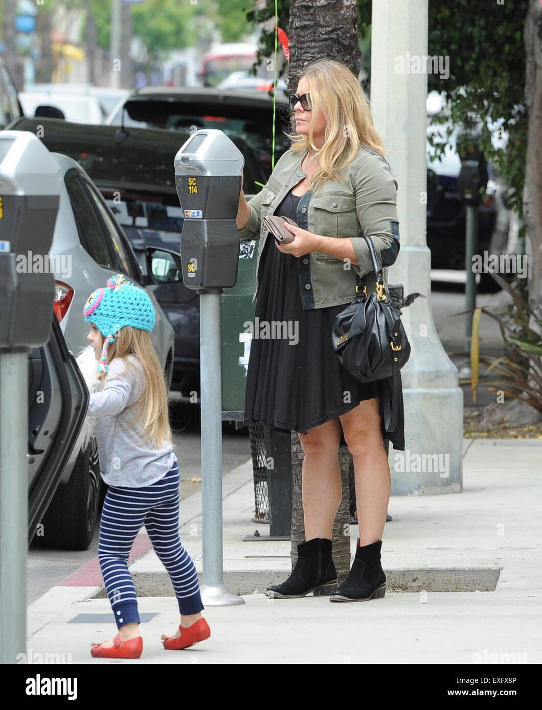 Ex baywatch babe Nicole Eggert feeds the meter before heading for brunch with her daughter in studio city.  Featuring: Nicole Eggert Where: Studio City, California, United States When: 12 May 2015 Stock Photo