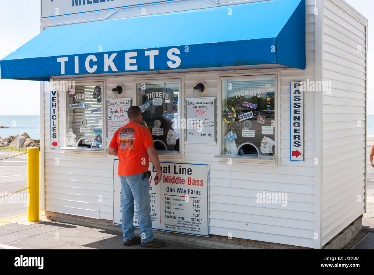 A man buys tickets for the Put-in-Bay ferry at the ticket booth in Catawba Island, Ohio. Stock Photo