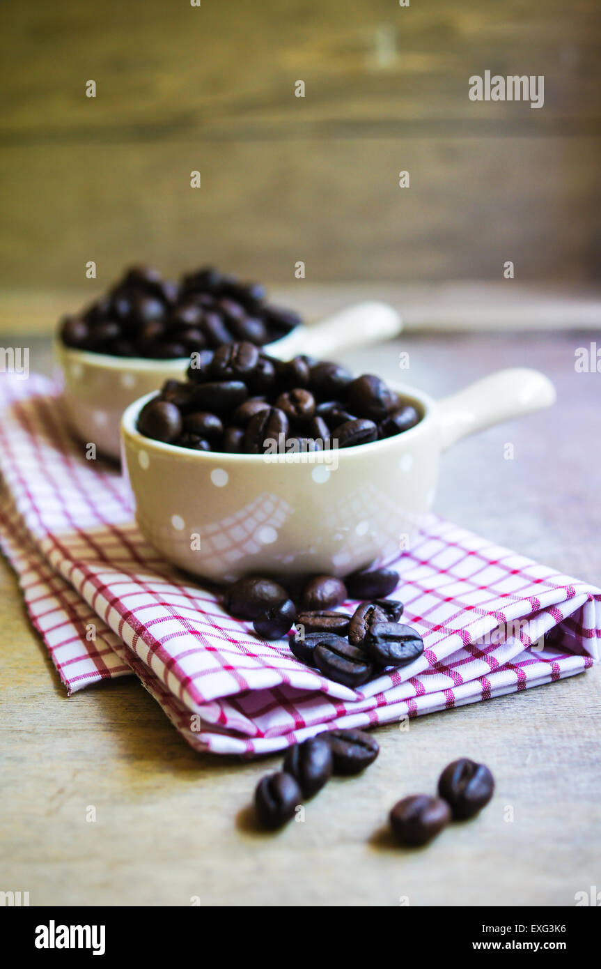 Coffee beans and vintage cups on the old table Stock Photo