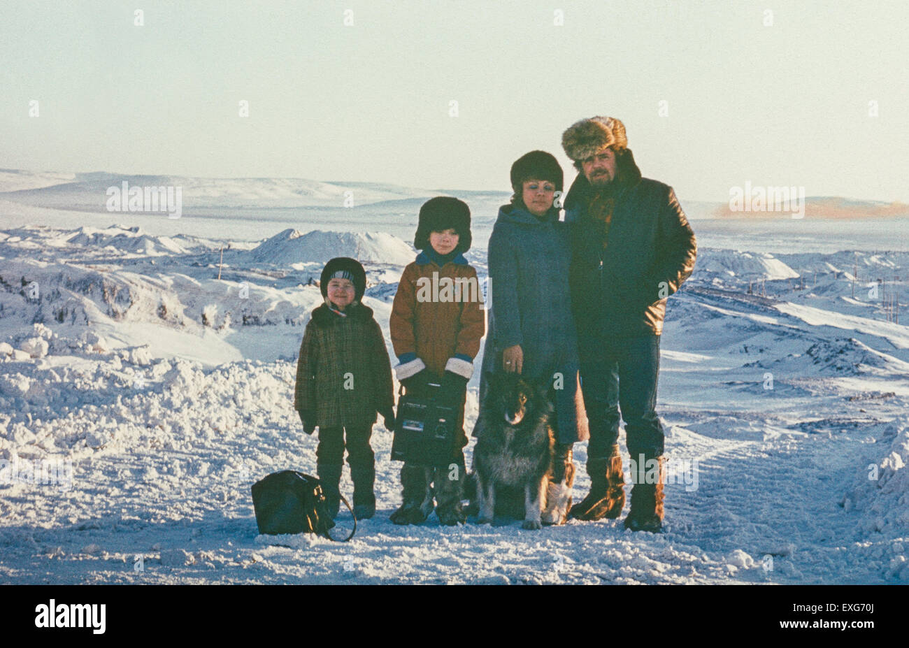 Chukchi Peninsula, USSR - April 10, 1985: Portrait of happy soviet family taken in tundra near most northern town in USSR called Stock Photo