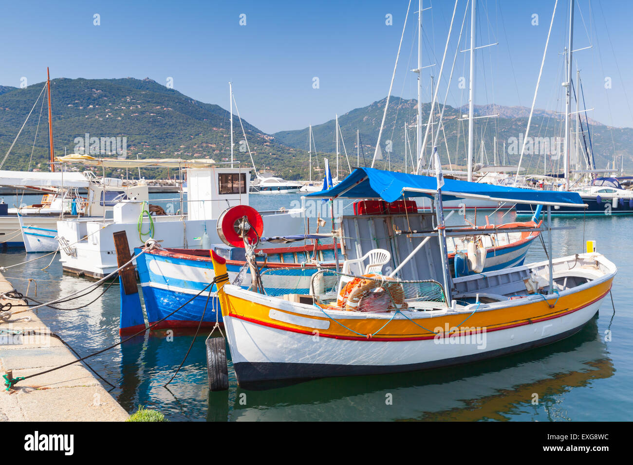 Small colorful wooden fishing boats moored in Propriano town, Corsica, France Stock Photo