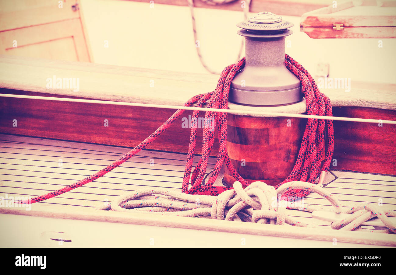 Vintage toned winch with rope on sailing boat, nautical background. Stock Photo