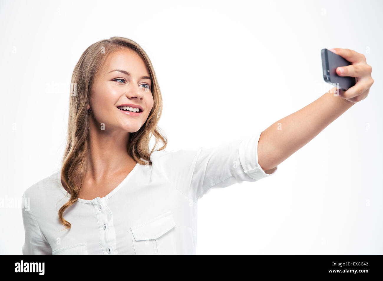 Happy young girl making selfie photo isolated on a white background ...