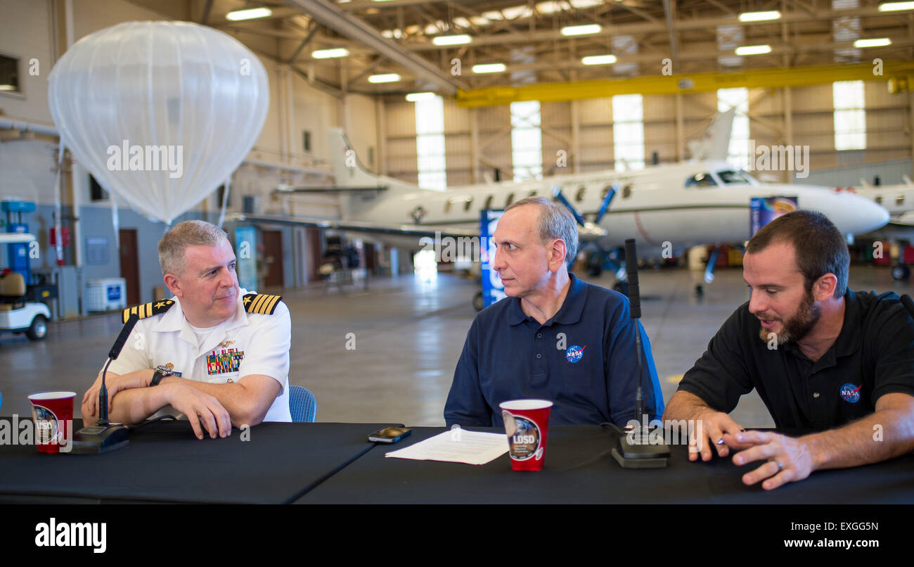 From left, U.S. Navy’s Pacific Missile Range Facility Commanding Officer Captain Bruce Hay, NASA Associate Administrator for the Space Technology Mission Directorate Steve Jurczyk, and NASA’s Jet Propulsion Laboratory (JPL) Low-Density Supersonic Decelerator (LDSD) Principle Investigator Ian Clark, talk at the conclusion of the LDSD flight test media briefing Monday, June 1, 2015, at the U.S. Navy Pacific Missile Range Facility (PMRF), Kauai, Hawaii. Stock Photo