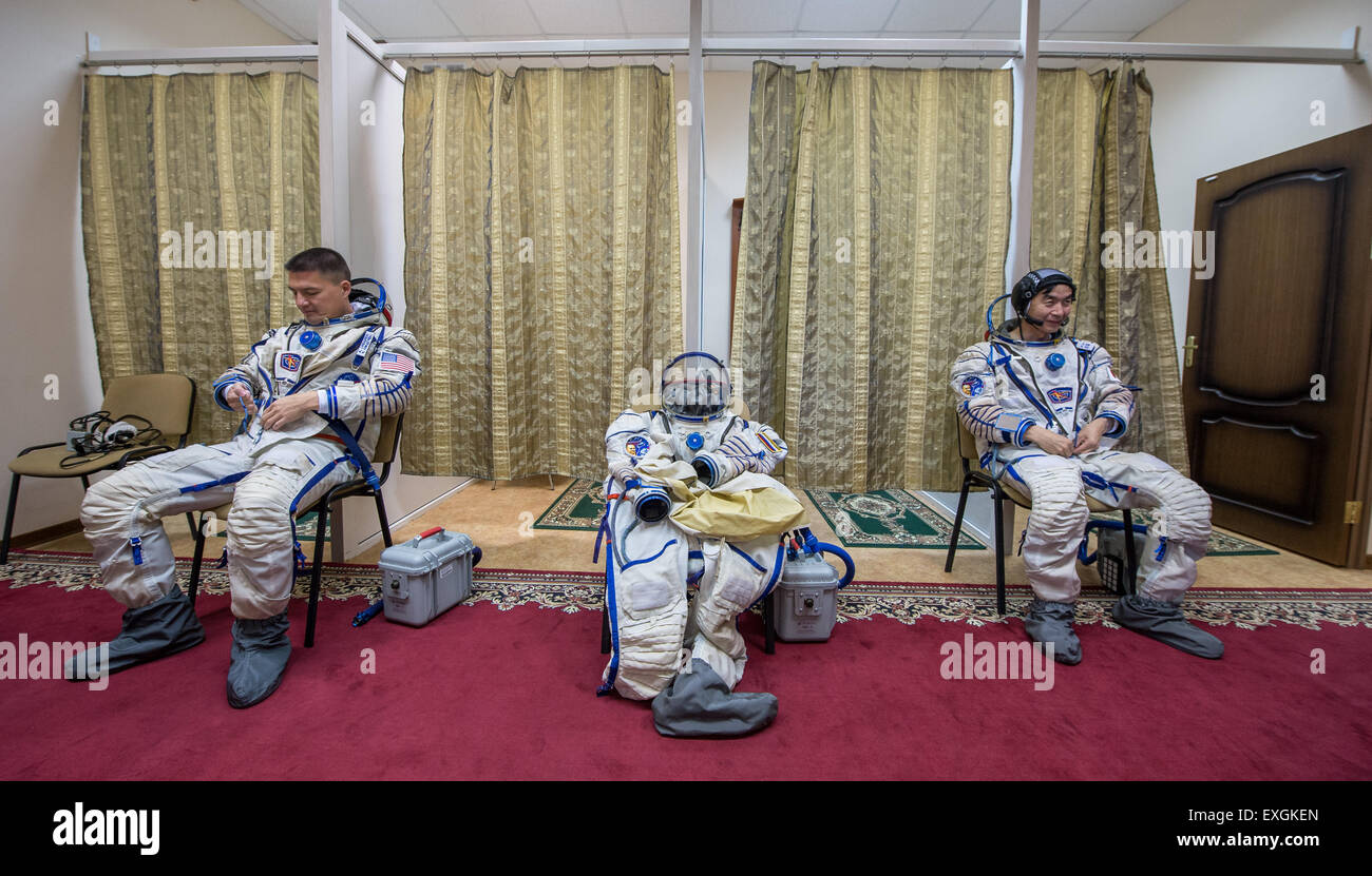 NASA astronaut Kjell Lindgren, left, and Japan Aerospace Exploration Agency astronaut Kimiya Yui wait for , Russian cosmonaut Oleg Kononenko to don his Russian sokol suit as they participate in the second day of qualification exams, Thursday, May 7, 2015 at the Gagarin Cosmonaut Training Center (GCTC) in Star City, Russia. The Expedition 44/45 trio is preparing for launch to the International Space Station in their Soyuz TMA-17M spacecraft from the Baikonur Cosmodrome in Kazakhstan. Stock Photo