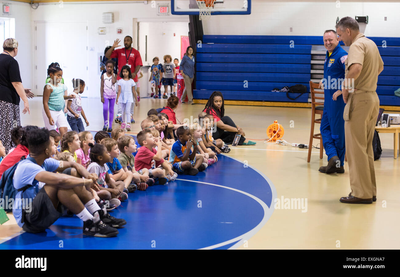 Astronaut Barry &quot;Butch&quot; Wilmore and Installation Commander Captain Frank Mays speak with students attending the Joint Base Anacostia-Bolling (JBAB) Summer Camp June 24, 2015 at JBAB in Washington, DC. Stock Photo