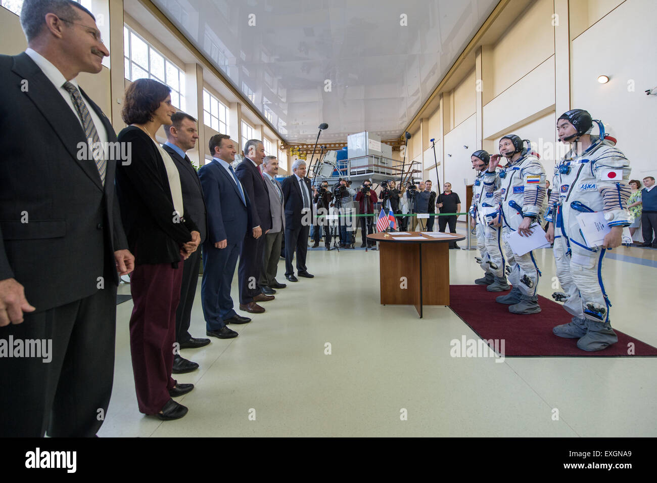 NASA astronaut Kjell Lindgren, Russian cosmonaut Oleg Kononenko, and Japan Aerospace Exploration Agency astronaut Kimiya Yui talk to officials during the second day of qualification exams, Thursday, May 7, 2015 at the Gagarin Cosmonaut Training Center (GCTC) in Star City, Russia. The Expedition 44/45 trio is preparing for launch to the International Space Station in their Soyuz TMA-17M spacecraft from the Baikonur Cosmodrome in Kazakhstan. Stock Photo