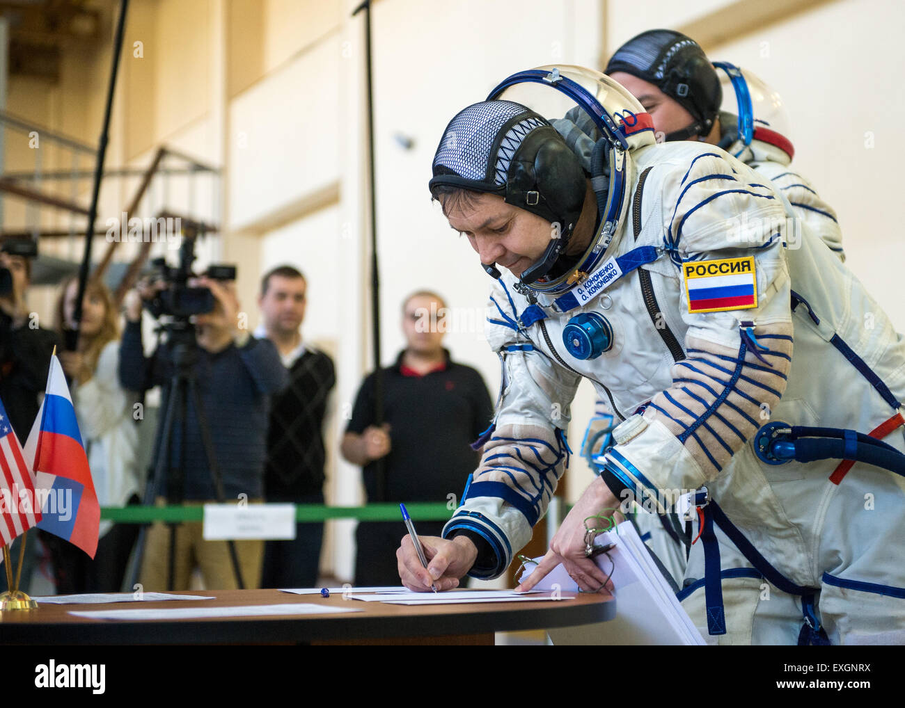 Russian cosmonaut Oleg Kononenko signs documents during the second day of qualification exams with NASA astronaut Kjell Lindgren and Japan Aerospace Exploration Agency (JAXA) astronaut Kimya Yui, Thursday, May 7, 2015 at the Gagarin Cosmonaut Training Center (GCTC) in Star City, Russia. The Expedition 44/45 trio is preparing for launch to the International Space Station in their Soyuz TMA-17M spacecraft from the Baikonur Cosmodrome in Kazakhstan. Stock Photo