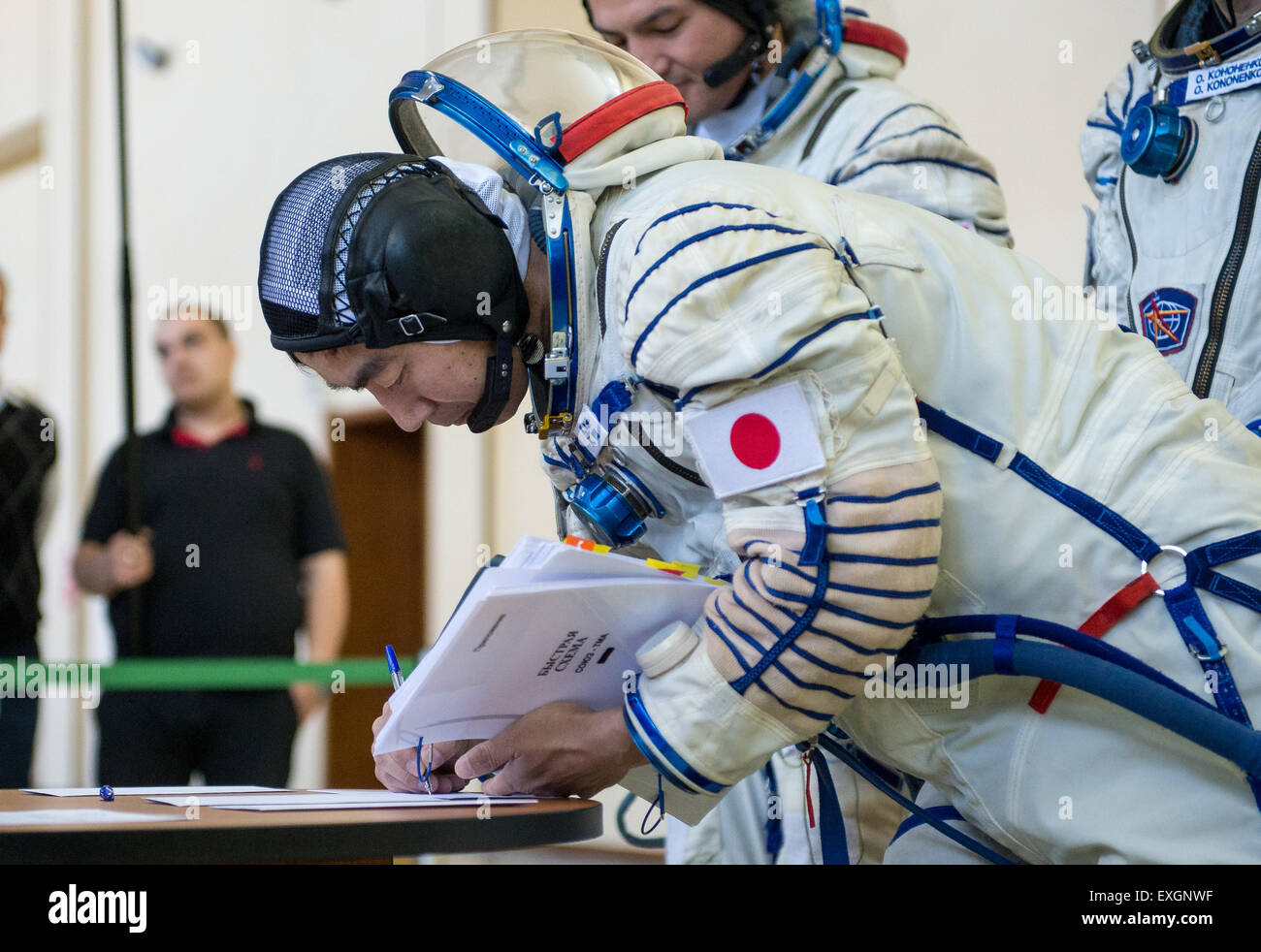 Japan Aerospace Exploration Agency astronaut Kimiya Yui signs documents during the second day of qualification exams with NASA astronaut Kjell Lindgren and Russian cosmonaut Oleg Kononenko, Thursday, May 7, 2015 at the Gagarin Cosmonaut Training Center (GCTC) in Star City, Russia. The Expedition 44/45 trio is preparing for launch to the International Space Station in their Soyuz TMA-17M spacecraft from the Baikonur Cosmodrome in Kazakhstan. Stock Photo