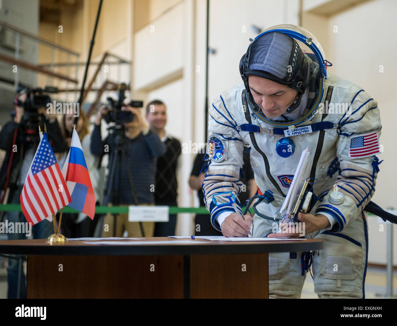 NASA astronaut Kjell Lindgren signs documents during the second day of qualification exams with Russian cosmonaut Oleg Kononenko and Japan Aerospace Exploration Agency (JAXA) astronaut Kimya Yui, Thursday, May 7, 2015 at the Gagarin Cosmonaut Training Center (GCTC) in Star City, Russia. The Expedition 44/45 trio is preparing for launch to the International Space Station in their Soyuz TMA-17M spacecraft from the Baikonur Cosmodrome in Kazakhstan. Stock Photo