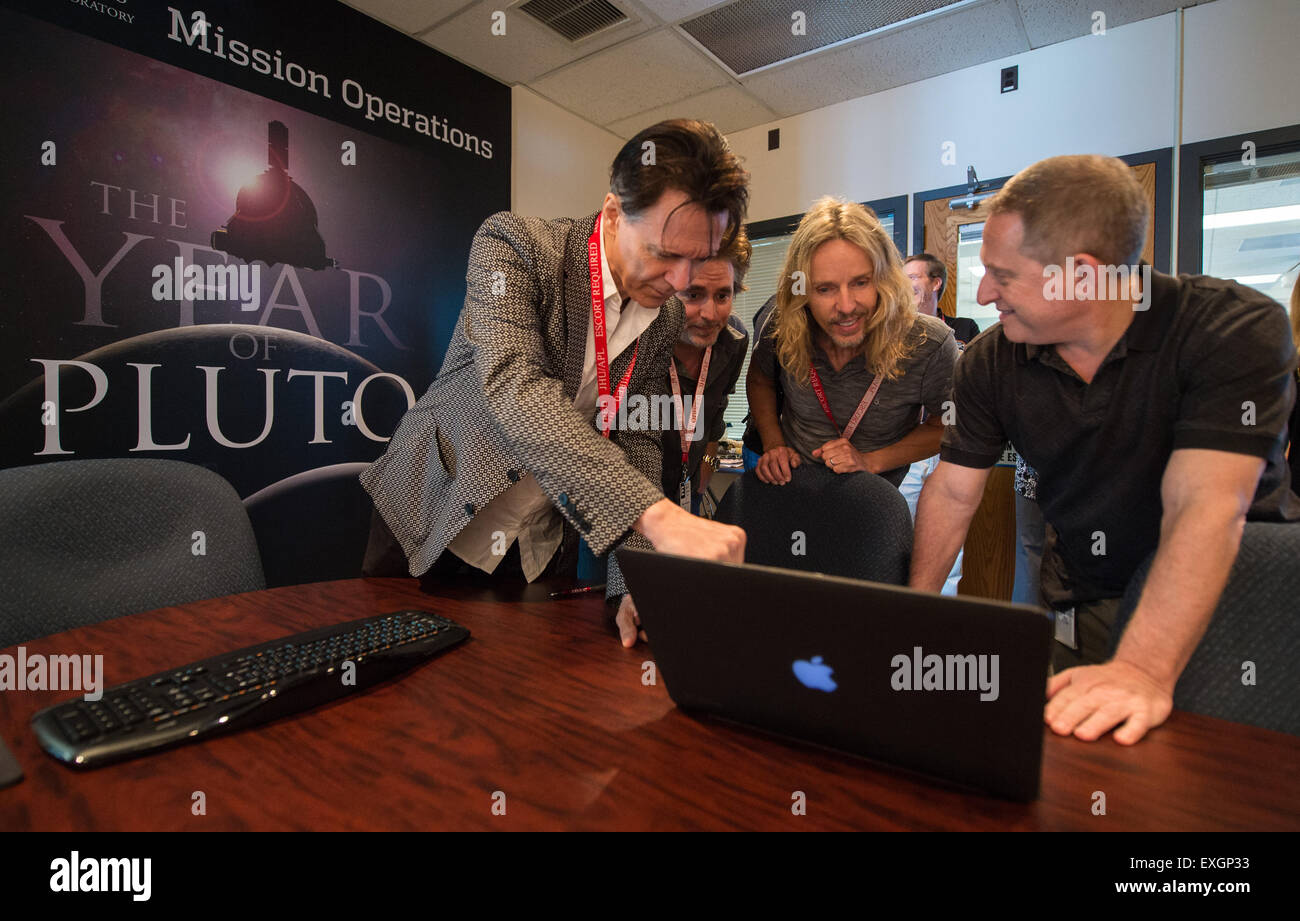 Lawrence Gowen, left, Todd Sucherman, and Tommy Shaw, of the band Styx, meet with Alan Stern, New Horizons principal investigator, Wednesday, July 1, 2015 at The Johns Hopkins University Applied Physics Laboratory in Laurel, Md.  Members of the band Styx visited with New Horizons team members and Mark Showalter, who discovered Pluto's fifth moon, Styx, in July of 2012. Stock Photo
