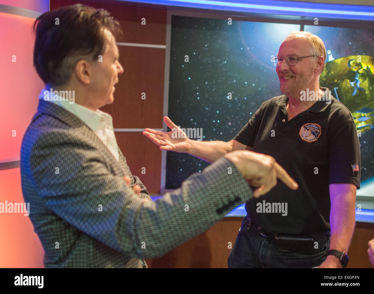 Mark Showalter, right, who discovered Pluto's moon Styx in 2012, speaks with Lawrence Gowen of the band Styx, Wednesday, July 1, 2015 at The Johns Hopkins University Applied Physics Laboratory in Laurel, Md.  Members of the band Styx visited with New Horizons team members and received a tour of the mission operations center. Stock Photo
