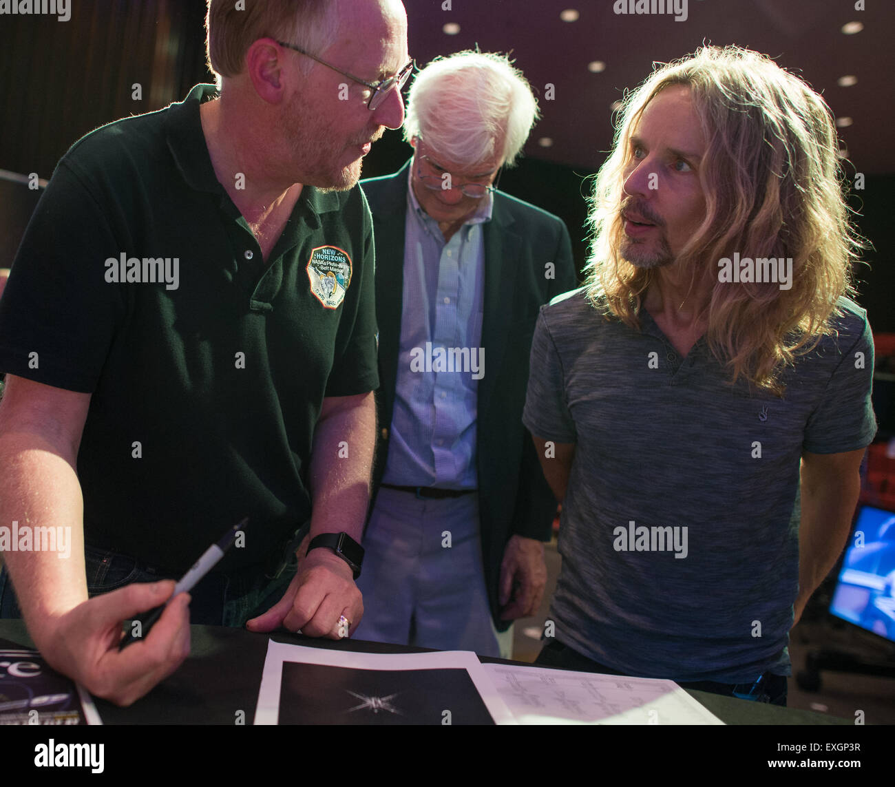 Mark Showalter, left, who discovered Pluto's moon Styx in 2012, speaks with Tommy Shaw of the band Styx, Wednesday, July 1, 2015 at The Johns Hopkins University Applied Physics Laboratory in Laurel, Md.  Members of the band Styx visited with New Horizons team members and received a tour of the mission operations center. Stock Photo