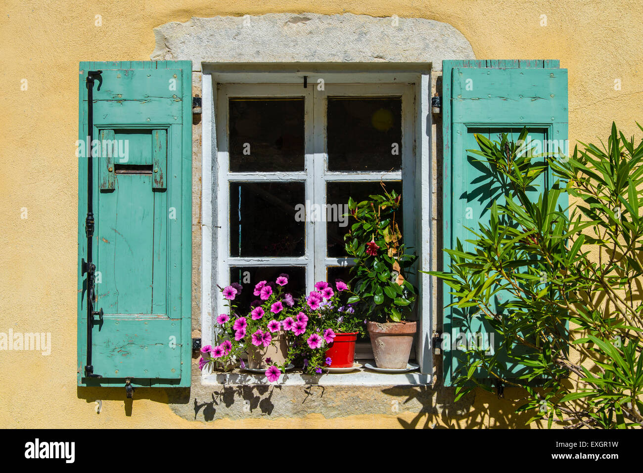 House window adorned with flowers in Provence, France Stock Photo