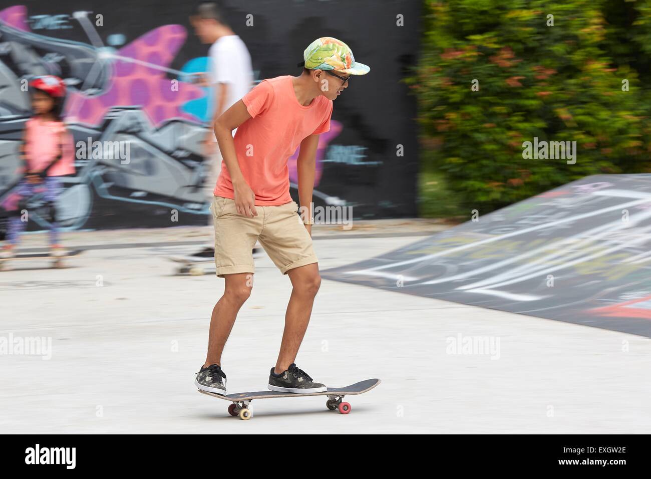 Young Singaporean Man Skateboarding in the SCAPE Skate Park, Singapore. Stock Photo