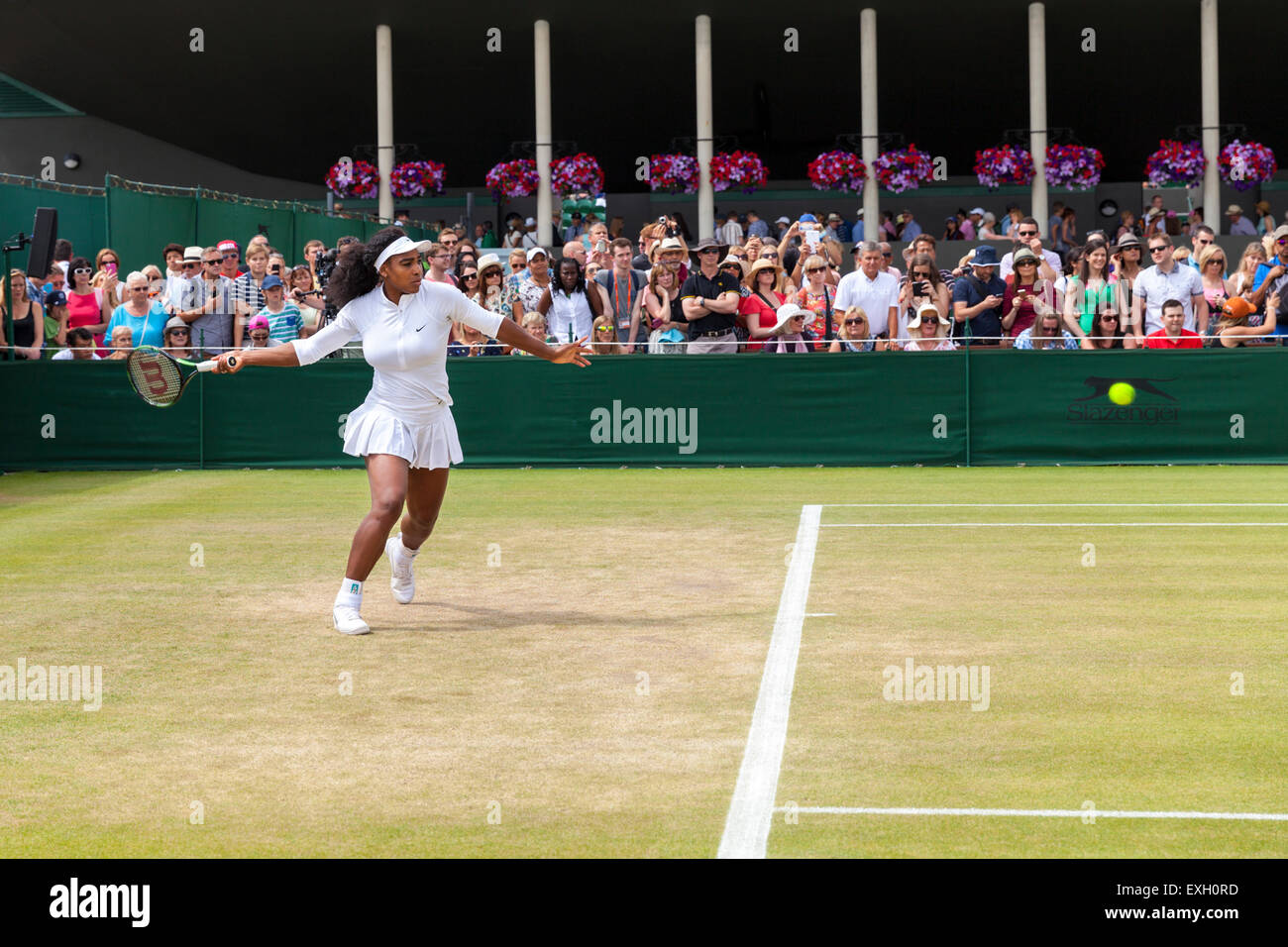 Serena Williams warms up for play helped by coach Patrick Mouratoglou, during the Wimbledon Championships 2015 Stock Photo