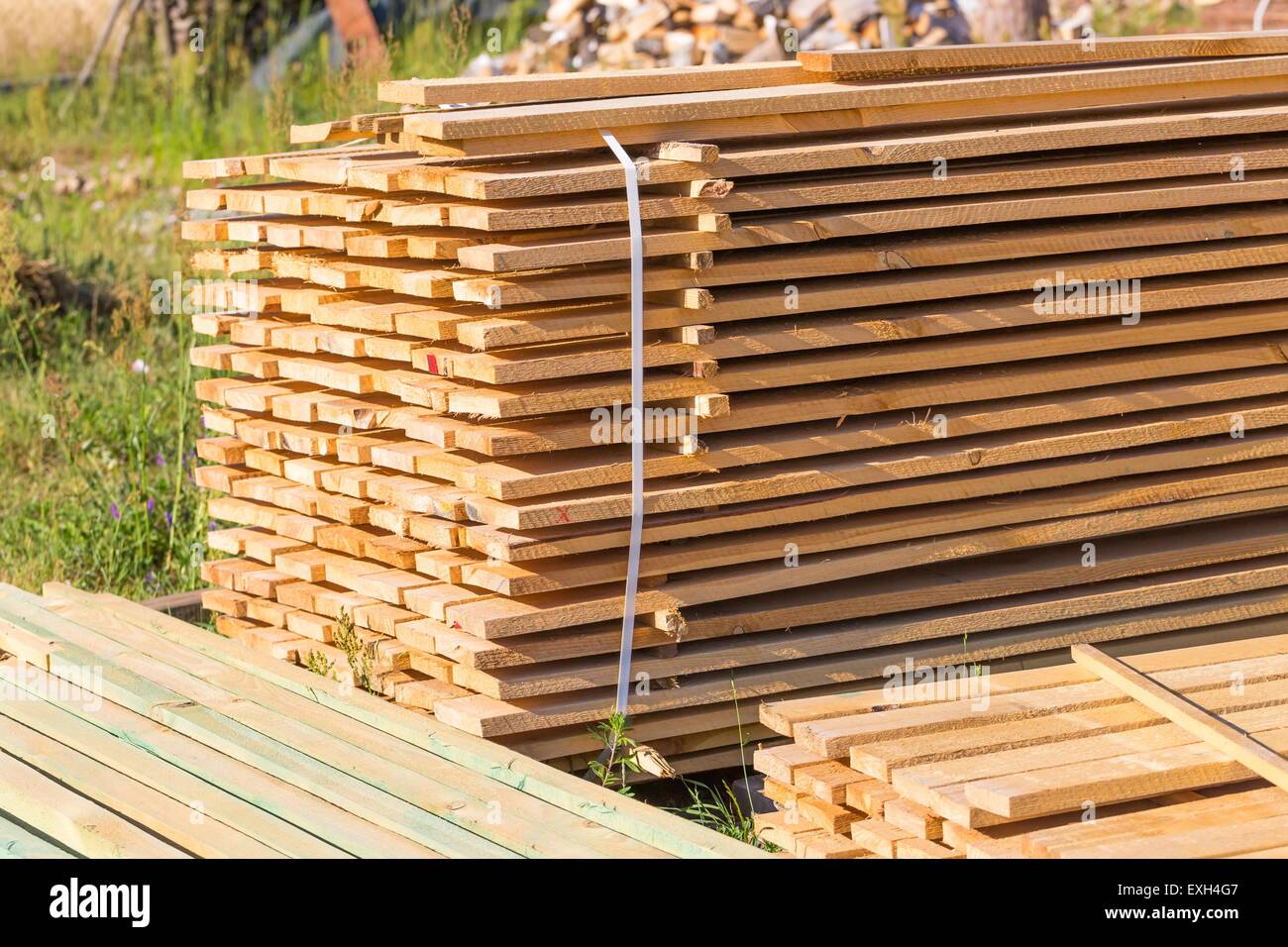 Boards from sawmill for house roof construction. Wooden planks lying in