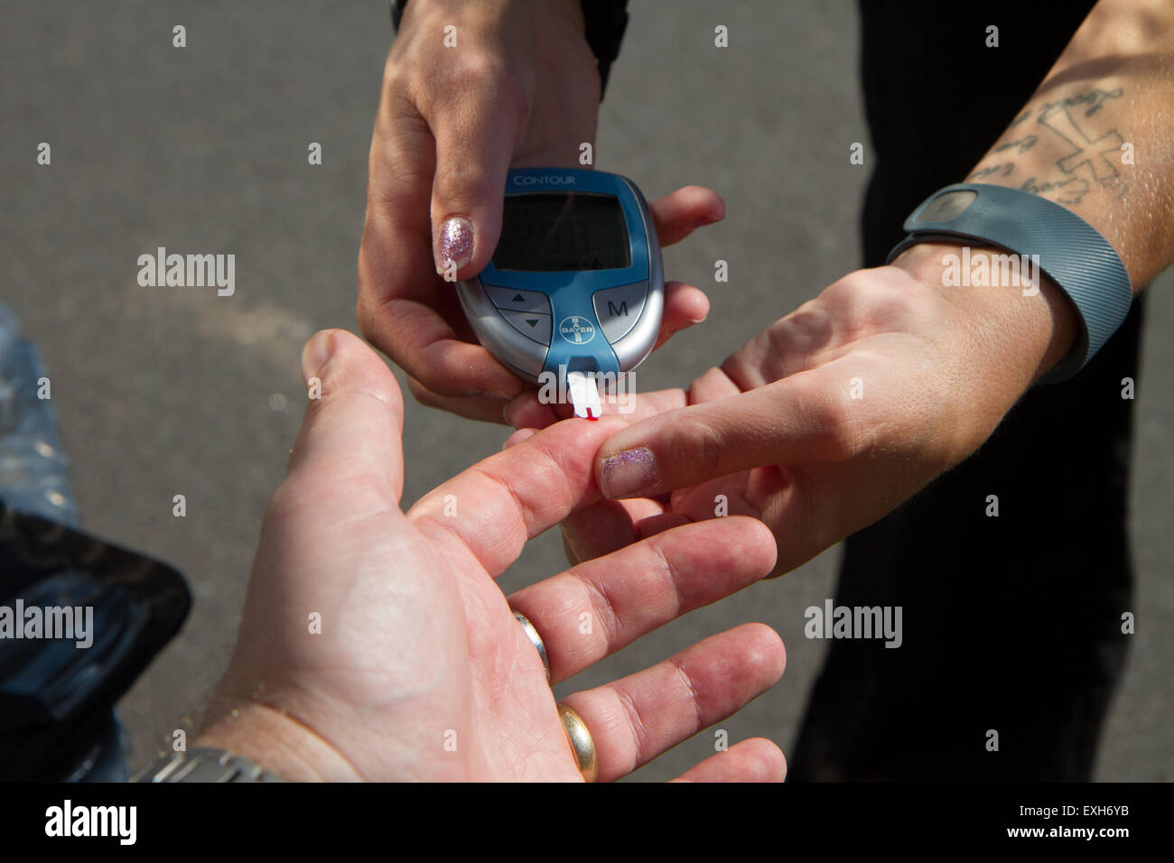 EMT / Paramedic administers blood sugar test in ambulance. Stock Photo