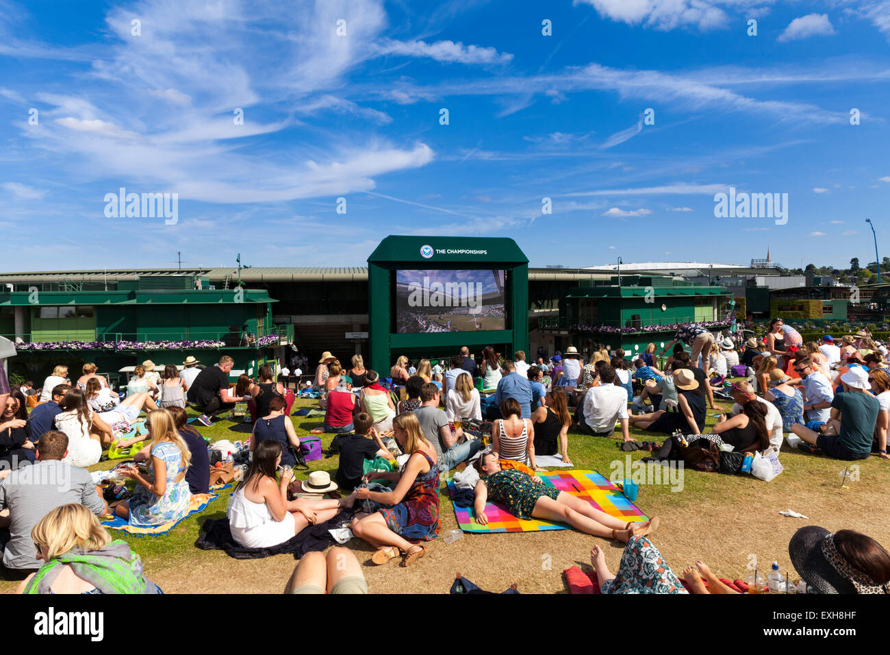 Spectators watch a tennis match on screens from the Hill at Aorangi Terrace, also known as Henman Hill or Murray Mount, during Wimbledon 2015 Stock Photo