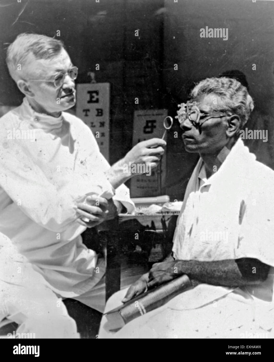 Dr. Victor Rambo examines a patient's eyes in India in 1958, providing ...