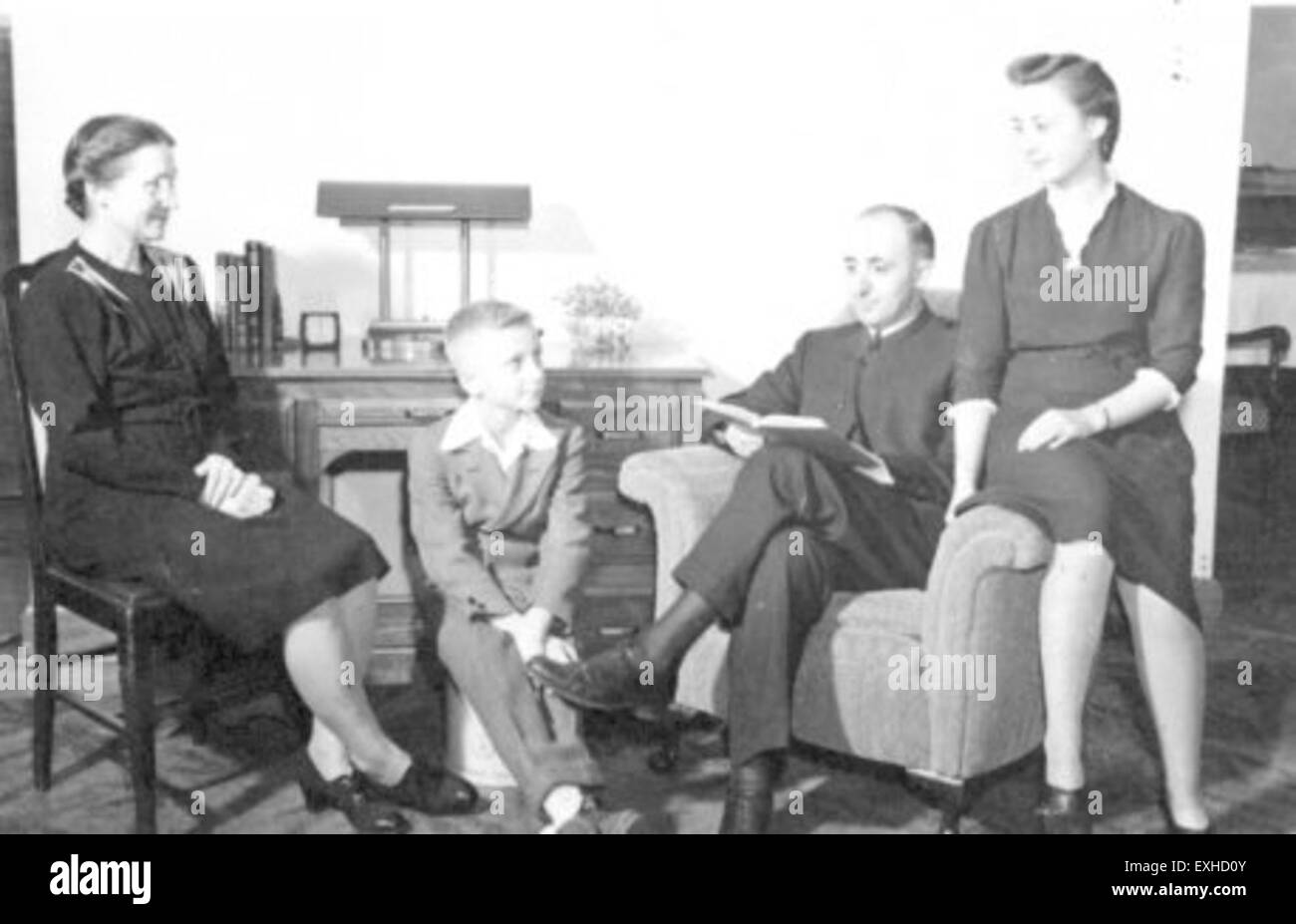Guy F. Hershberger is seen with his family in Goshen, Indiana, a location associated with Mennonite culture and community service, likely representing family involvement in local outreach activities. Stock Photo