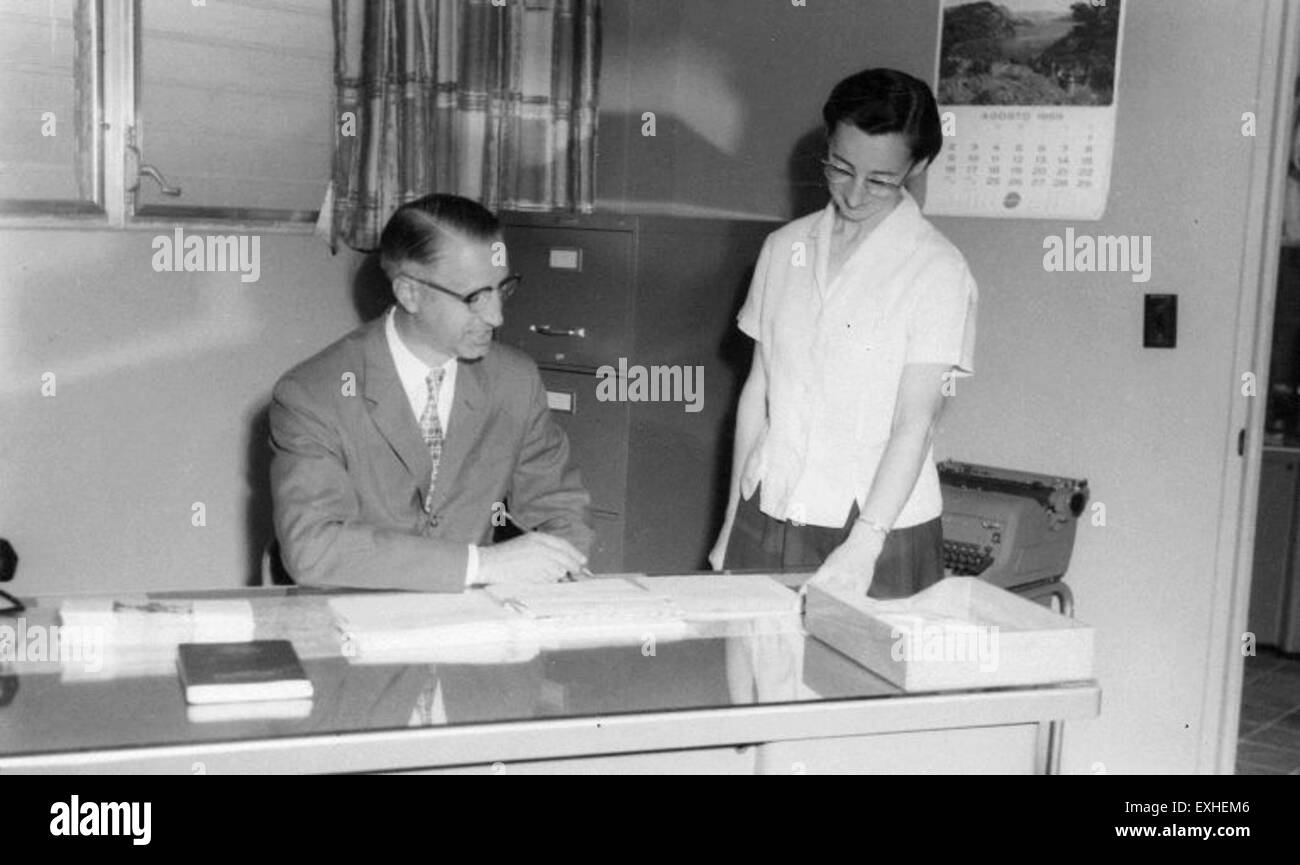 John Lehman and Mary Ellen Yoder at the Luz y Verdad office, possibly involved in mission work or community outreach as part of a Mennonite service program. Stock Photo